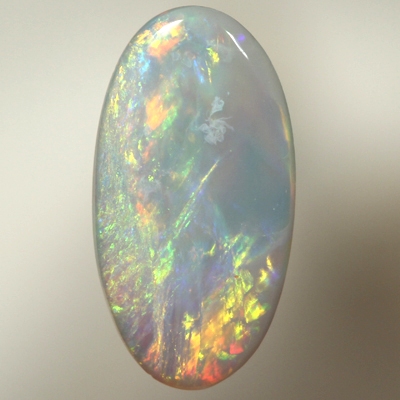 SOLID SEMI BLACK OPAL Orange and greens over ocean blue